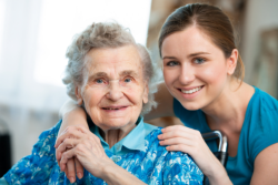 Caregiver and elder smiling